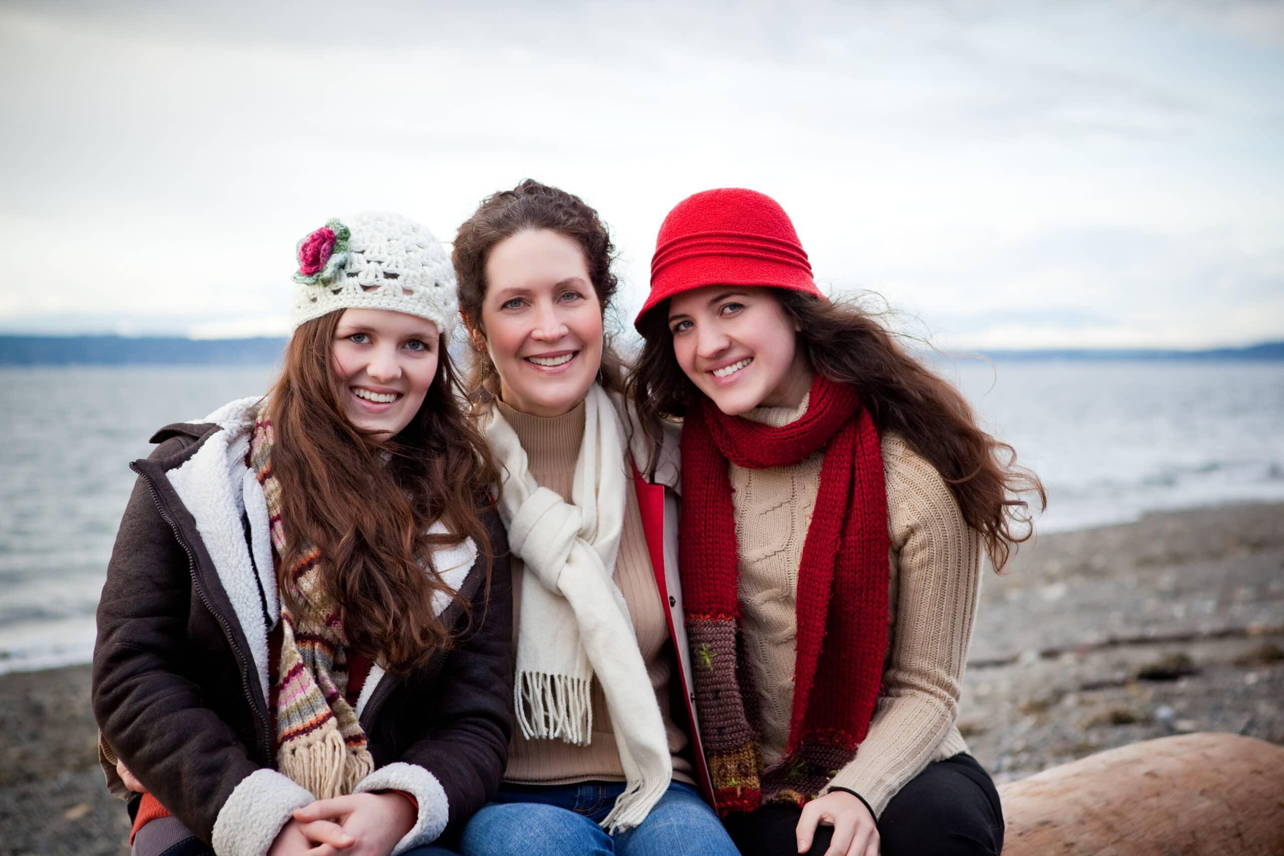 A portrait of a mother and her daughters on the beach
