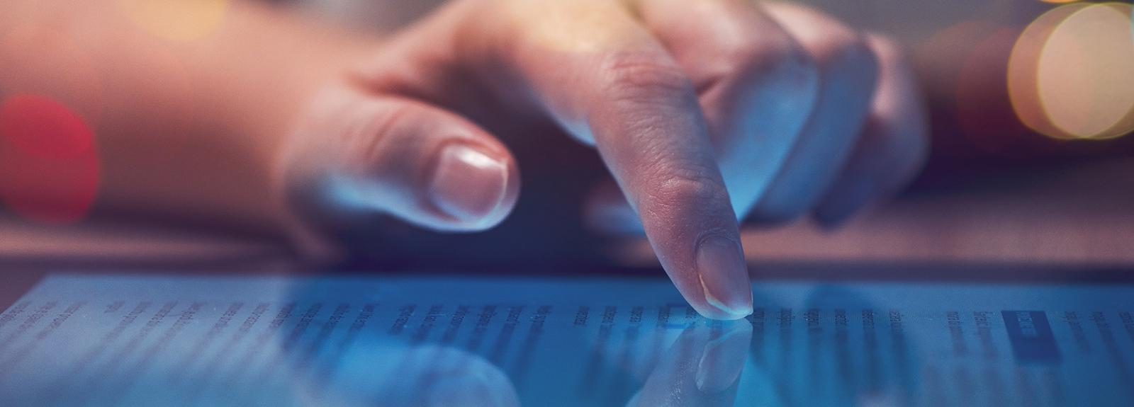 Close up of a hand using a tablet