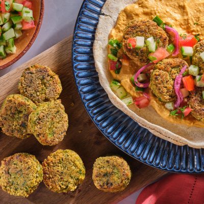 Falafel Pitas with Tahini plated next to hummus