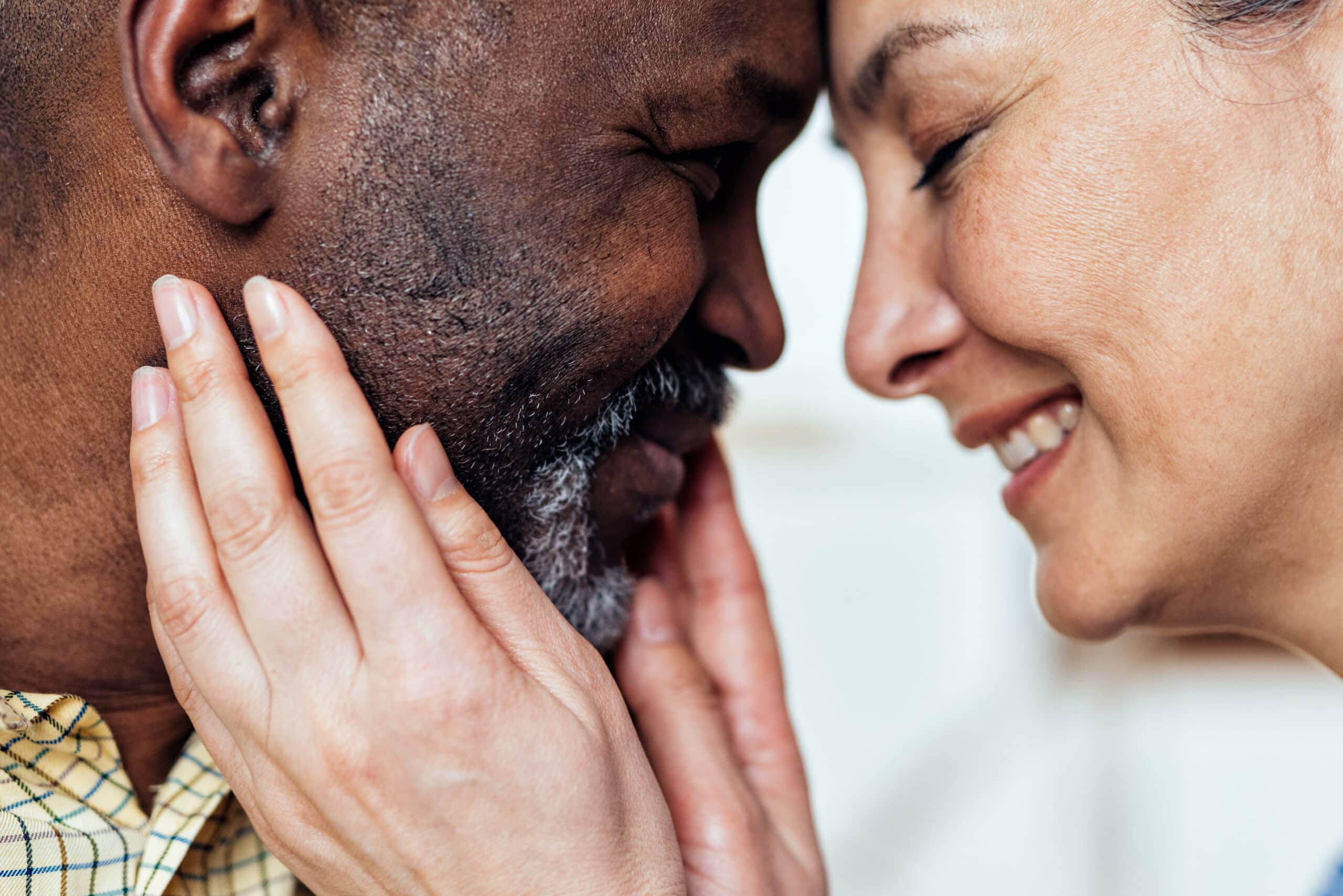 cinematic image of an happy multiethnic senior couple. Indoors Lifestyle moments at home. Concept about seniority and relationships