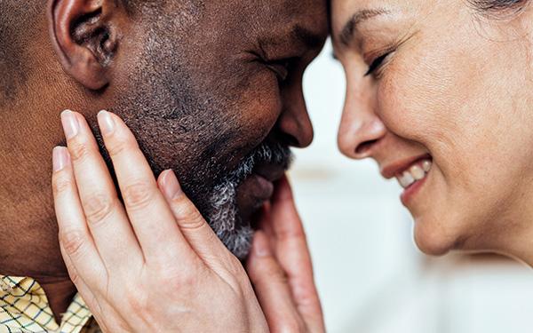 cinematic image of an happy multiethnic senior couple.